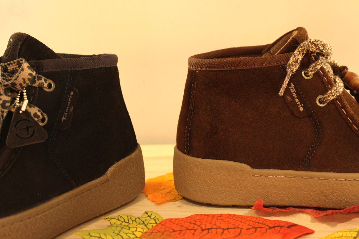 Bottines Tamaris en croûte de cuir de couleur chocolat ou de couleur muscat. Lacets coton imprimé et pampille.