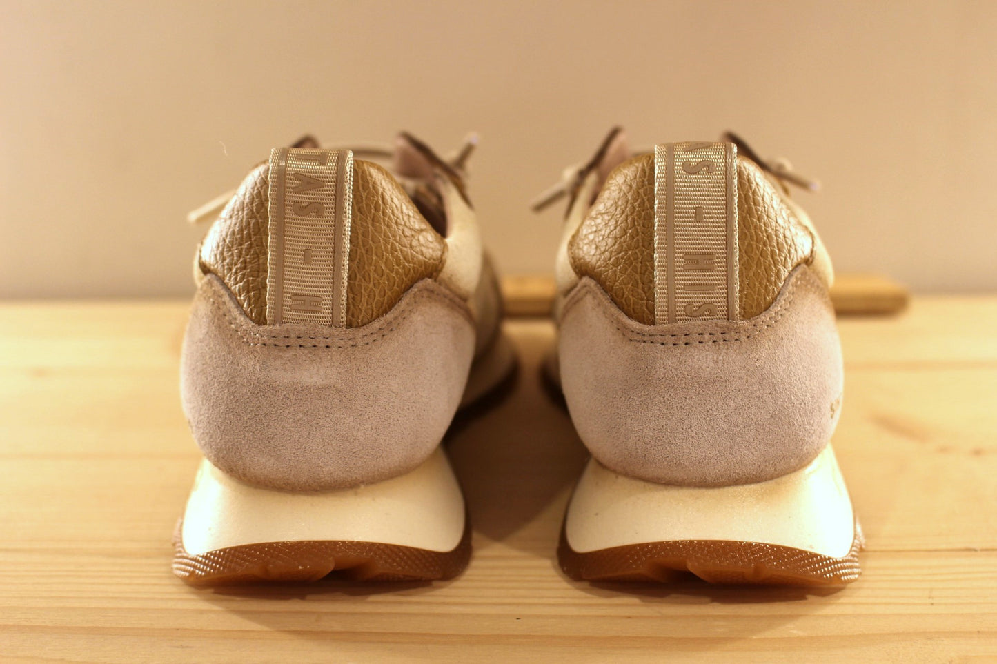 Basket en cuir de couleur crème et métallisé étain. Languette en laine bouclette ton sur ton. Lacets élastiqués beige.