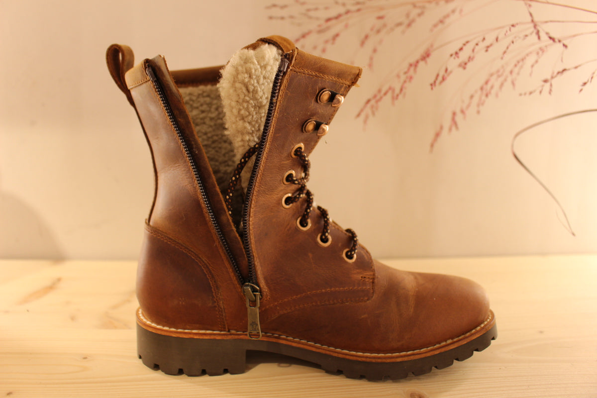 Bottines Panama jack en cuir gras de couleur cuir. Laine bouclette sur la languette. Chaussures doublées laine