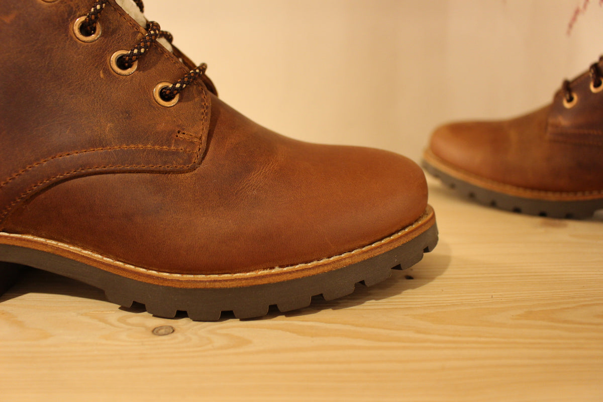 Bottines Panama jack en cuir gras de couleur cuir. Laine bouclette sur la languette. Chaussures doublées laine