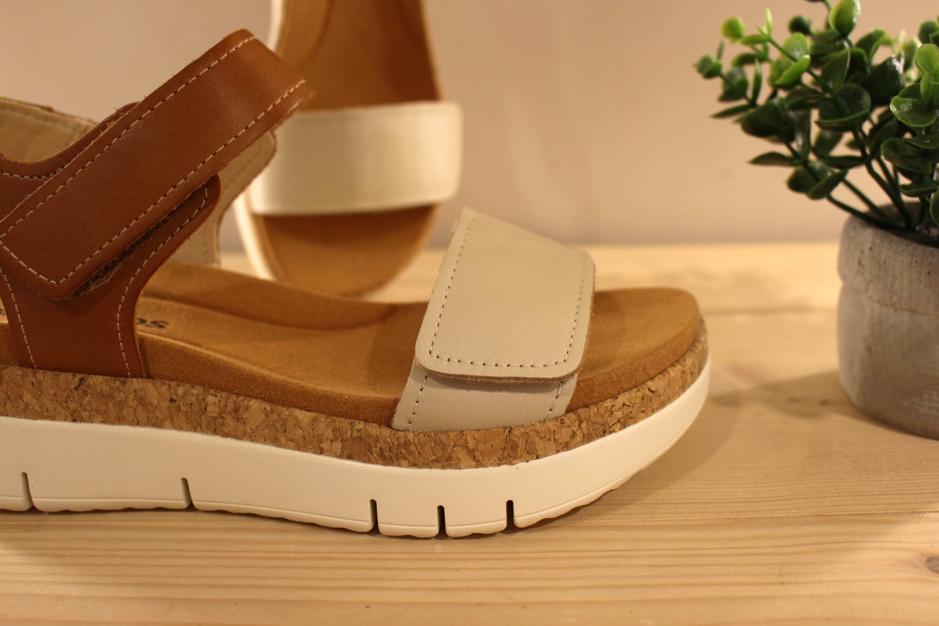 Sandales en cuir de couleur blanc cassé et camel. Serrage par deux scratchs, sur bride coup de pied et sur bride avant PIKOLINOS