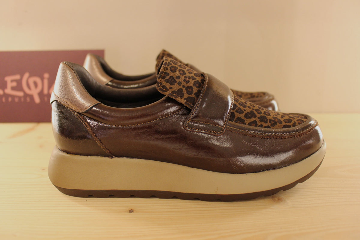 Mocassins REQINS en cuir vernis de couelur chocolat. Claque imprimée léopard ton sur ton. Métallisé bronze sur l'arrière